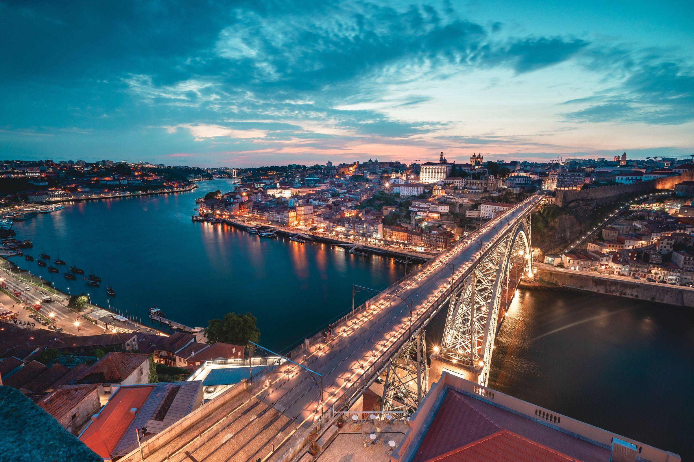 representative image of the city of Porto. Illuminated bridge, with the banks of the cities of Porto and Vila Nova de Gaia in the background, captured at night